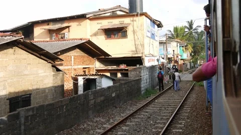 Window view from Srilankan train that goes through small village Stock Footage 234725225