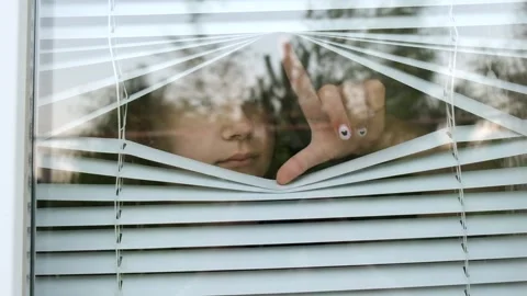 A window with a view of trees and a reflection of a hand Stock Footage 274066047