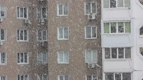 Window view in winter day, snowflakes falling down. Snowstorm in city Stock Footage 207570689