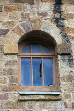 Window in the wall of an old castle. Stock Photos