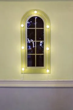 Window on the wall of a private house close-up, pistachio-colored walls Stock Photos