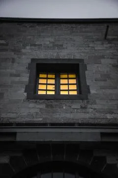 Window on a wall with yellow lights 写真素材