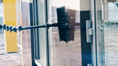 Window washer cleaning building facade Stock Footage 103188951