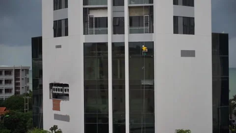 Window washer on high rise building Video stock 140322153