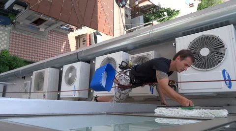 Window Washer Working  At The Windows Of A Business Building, Alpindustry Stock Footage 63882138