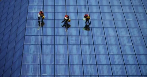 Window washers (climbers) on a modern office building Stock Footage 91005662