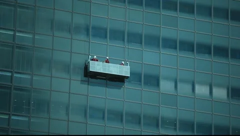 Window washers going up Stock Footage 987677