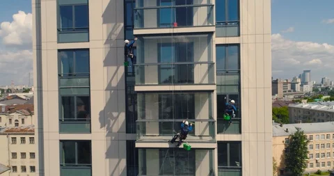 Window Washers on a Office Building. Industrial climber - Facade Cleaning Stock Footage 104499990