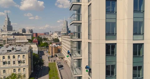 Window Washers on a Office Building. Industrial climber - Facade Cleaning Stock Footage 104500487