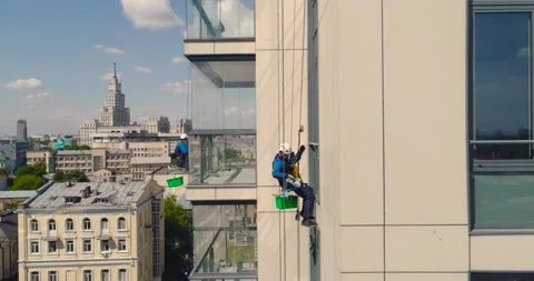 Window Washers on a Office Building. Industrial climber - Facade Cleaning Stock Footage 131559082