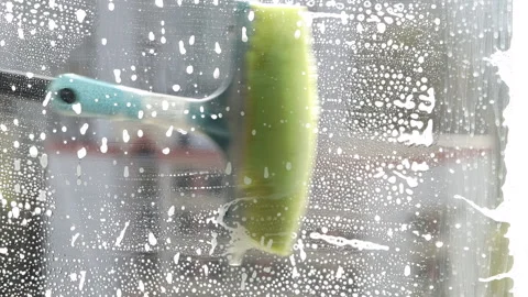 Window washing with a brush and foaming agent Stock Footage 241887096