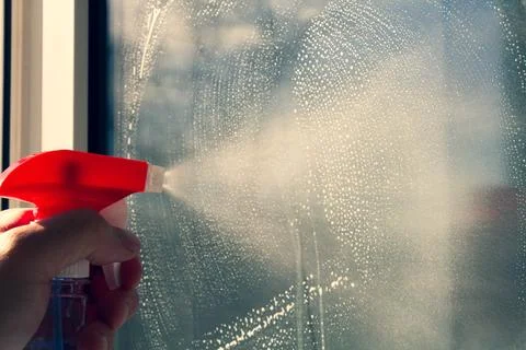 Window washing. Cleaning the window with a brush and foam. The concept of Stock Photos