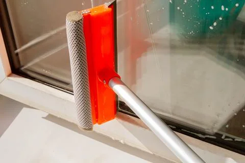 Window washing. Cleaning the window with a brush and foam. The concept of c.. Stock Photos