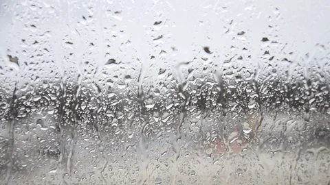 The window is wet from the rain. Rainwater streams down the glass. Stock Footage 123413148