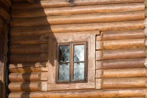 A window in a wooden wall with the reflection of sunlight Stock Photos