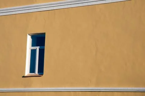 The window on the yellow wall. Stock Photos