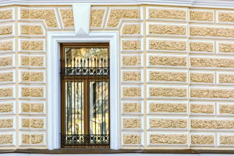 Window on yellow wall. Stock Photos