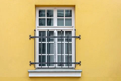 Window on yellow wall. Stock Photos
