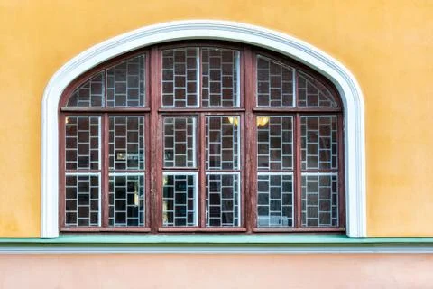 Window on the yellow wall. Stock Photos