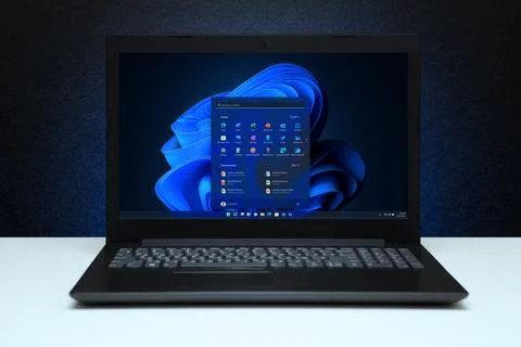 Windows 11 Desktop with logo on the screen laptop computer on black texture.. 스톡 사진