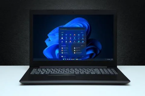 Windows 11 Desktop with logo on the screen laptop computer on black textured  Stock Photos