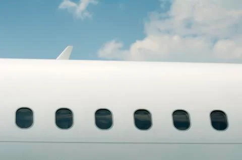 Windows of an airplane outside Stock Photos