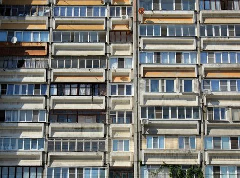 Windows and balconies of old multi-storey building Stock Photos