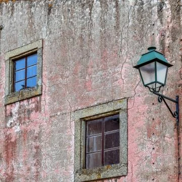 Windows and lamppost in an old facade. Almeida, Portugal Stock Photos