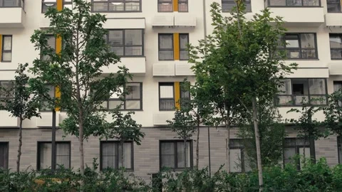 The windows of an apartment building with lots of trees and vegetation Stock Footage 223134889