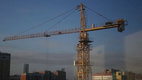 Windows of an apartment house with a view of the construction crane at a Stock Footage 72243621