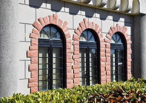 Windows with an arch on the facade of wall Stock Photos