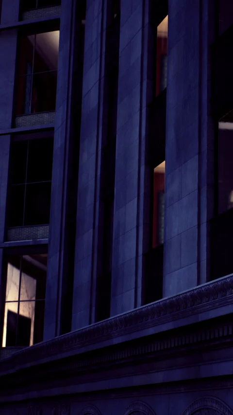 Windows are illuminated in a building during the evening hours in the city Stock Footage 331758949