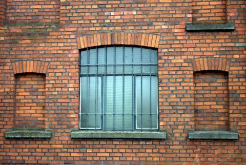 Windows on the background of a red wall Stock Photos