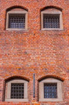 Windows with bars of medieval prison Stock Photos