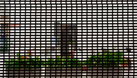 Windows behind bars, close up Stock Photos