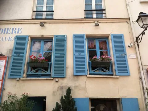 Windows with blue shutters Stock Photos