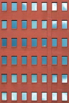 Windows of a brick building texture. Abstraction. Stock Photos
