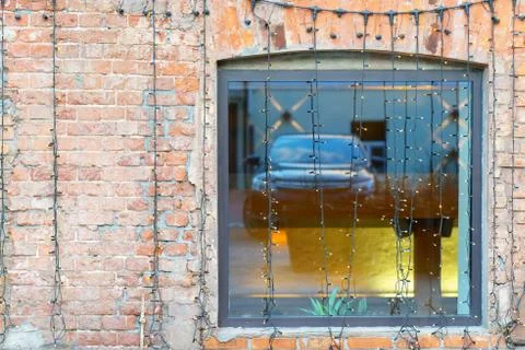Windows in a brick wall with the reflection of the machines Stock Photos
