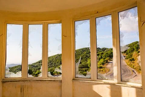 Windows with broken glass view from inside one of the houses on the island of Stock Photos