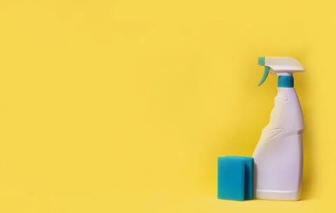 Windows cleanser with sponge on yellow background. minimalistic composition Stock Photos