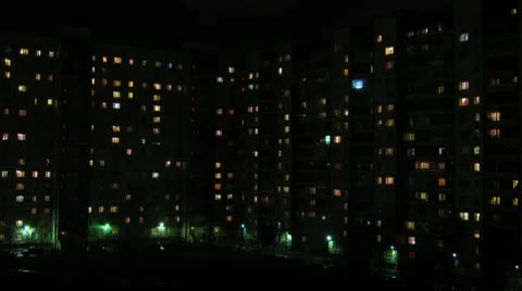 Windows in houses are lit at night and go out - timelapse Stock Footage
