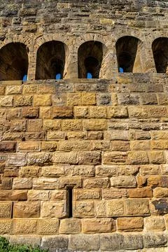 Windows inside of the massive high walls of an old medieval castle Photos