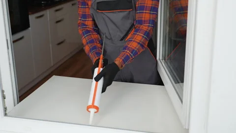Windows installation worker use of foam when installing windows Stock Footage 268276230