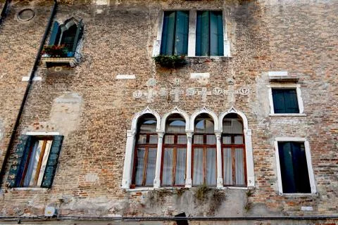 Windows mixed on brick wall building Stock Photos