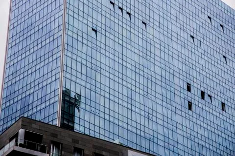 Windows of modern office building texture seen from below Stock Photos