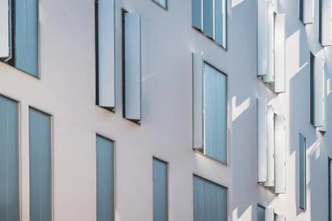 Windows with modern shutters creating light and shadows Stock Photos