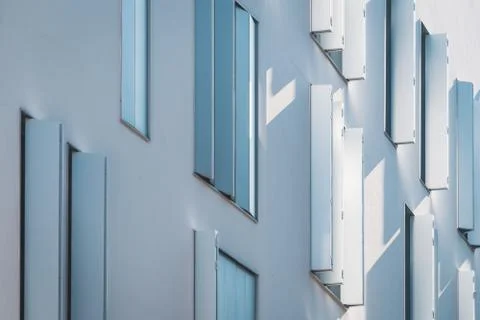 Windows with modern shutters creating light and shadows Stock Photos