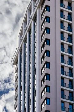 Windows of multi-storey building on the background of sky Stock Photos