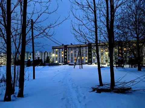 Windows in a multi storey building at night in winter. Stock Photos