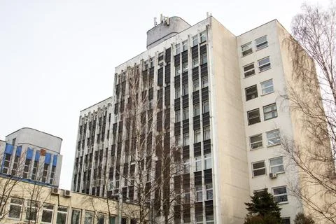 Windows of multi-storey tall building against background of sky Stock Photos